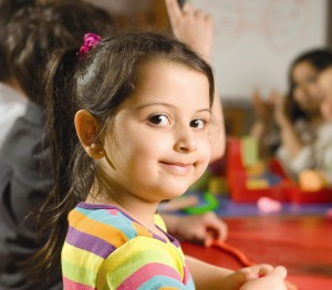 "Young smiling girl in child care center"